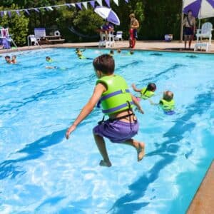 This image captures a vibrant summer scene at a swimming pool.