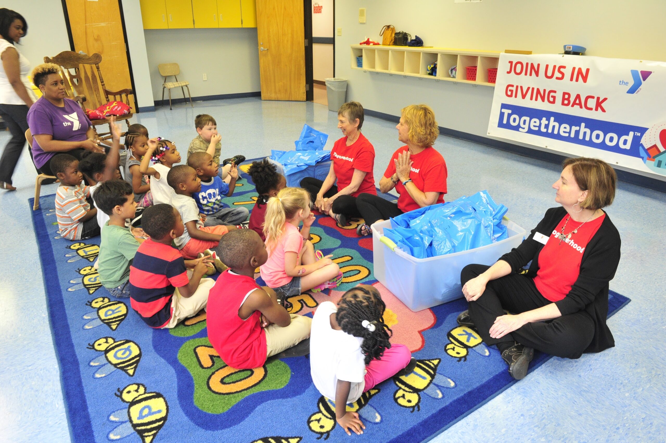 Volunteers donate six books each to the preschool students at the downtown YMCA on Monday, May 23, 2016 in Huntsville, Ala. (Eric Schultz / Rocket City Photo)